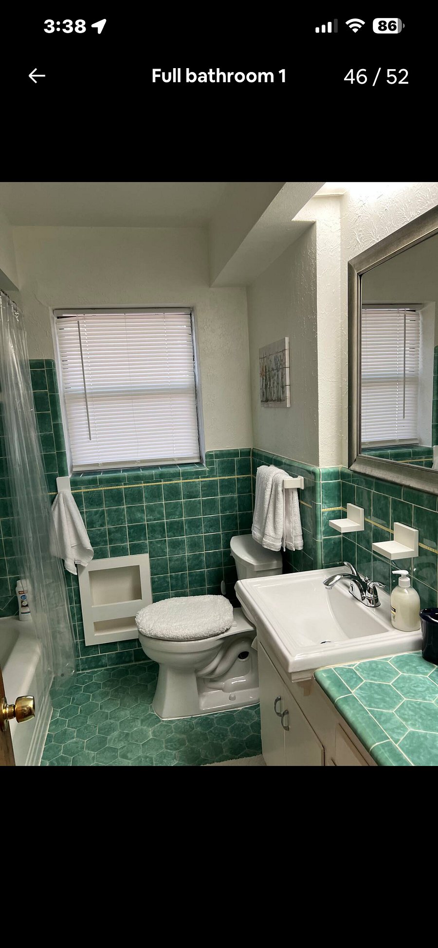 Full sized tub/shower in main bath. You have to see these unique 1950s iridescent tiles.