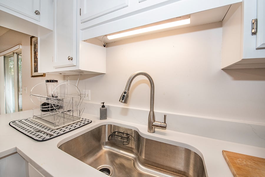 Quartz countertops and large kitchen workspace.