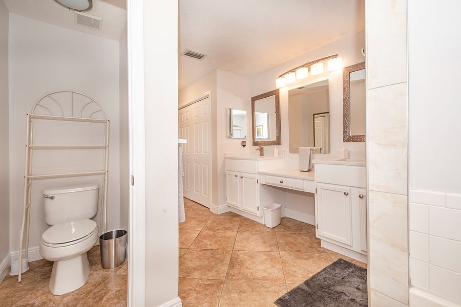 Spacious master bath with his & her vanity and center makeup desk and garden tub.
