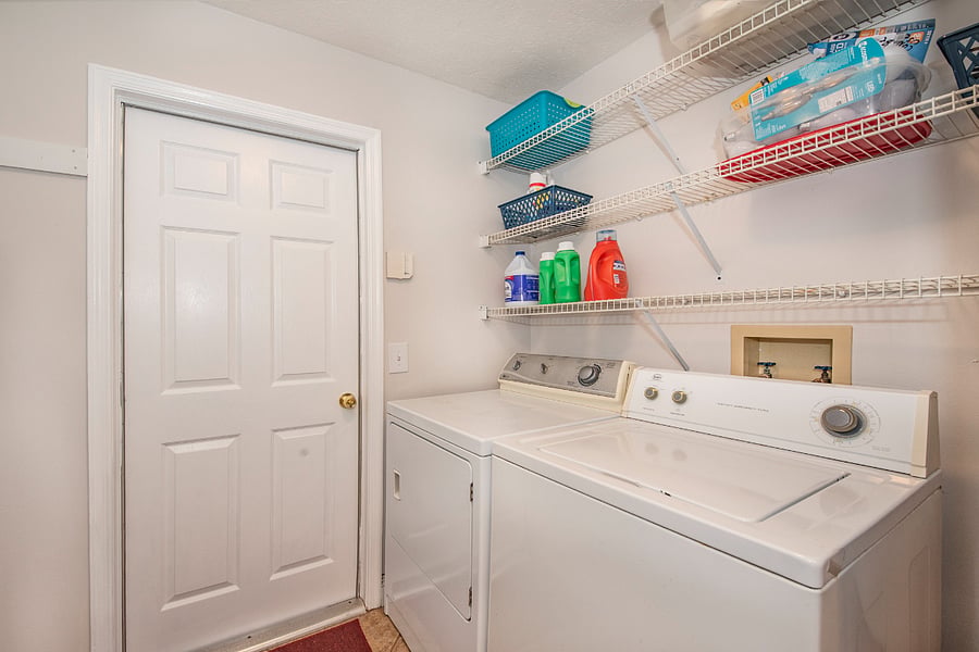 Laundry room with large washer & dryer and storage space