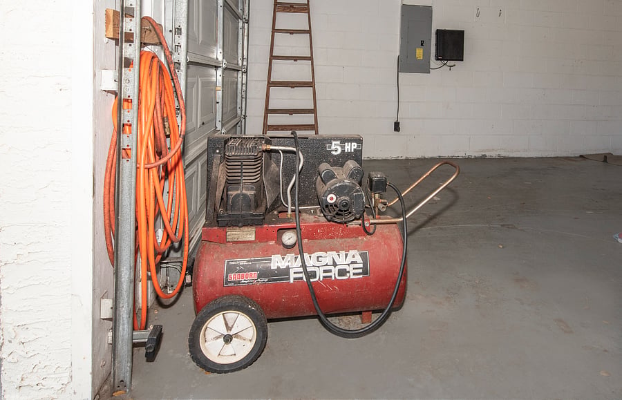 Garage workspace with air compressor.