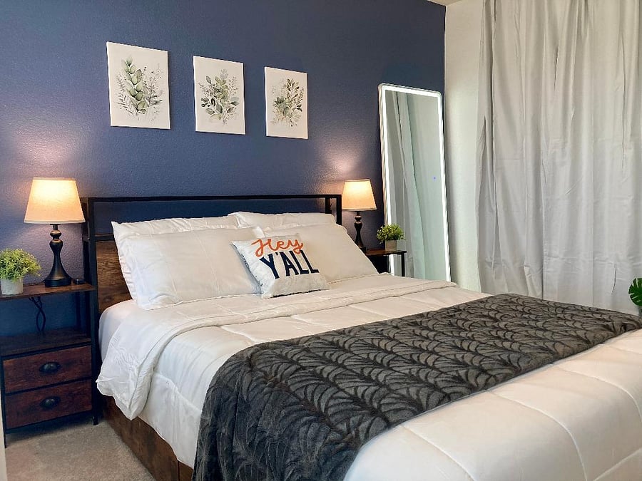 Guest Room, Queen Size Bed and features a lighted full length mirror and a 65" UK UHD Roku TV.