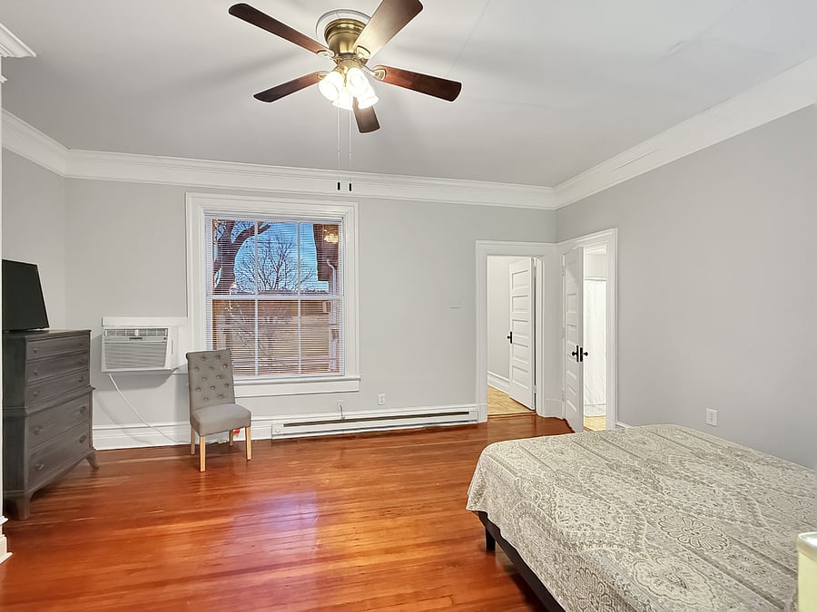 Bedroom with view into secondary room and full bathroom