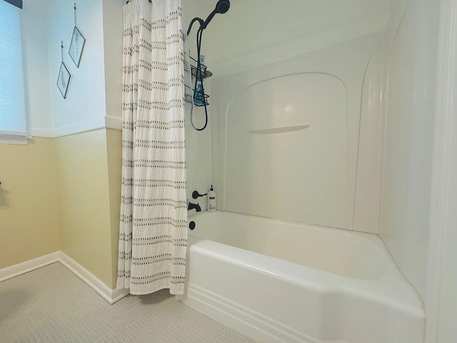 Clean, updated bathroom featuring a full tub.