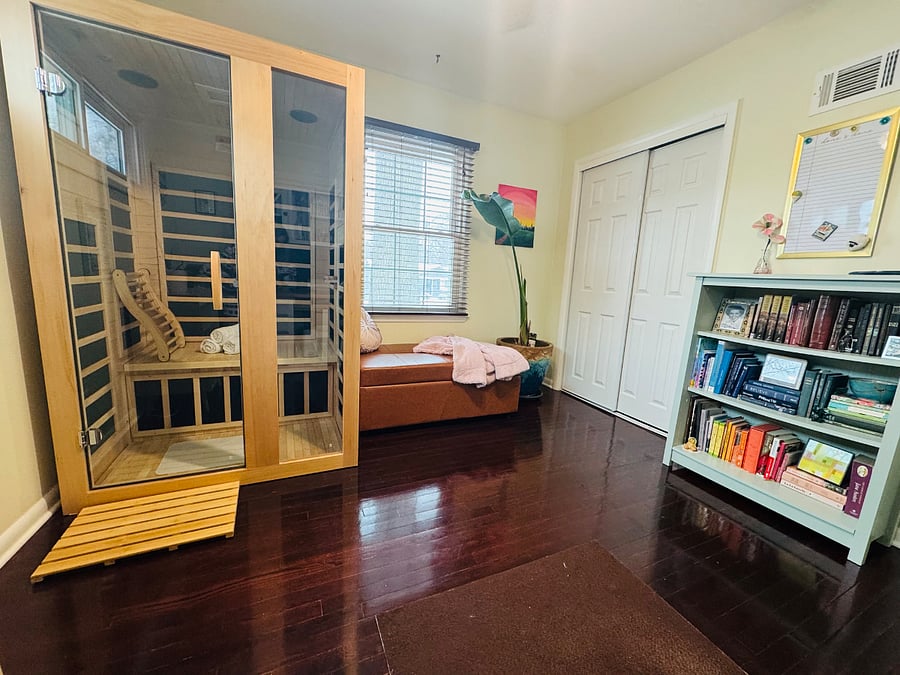 Bedroom 3: Private in-home two-person infrared sauna a rare luxury for relaxation, recovery, and wellness during your stay. The ottoman easily converts into a comfortable twin bed.