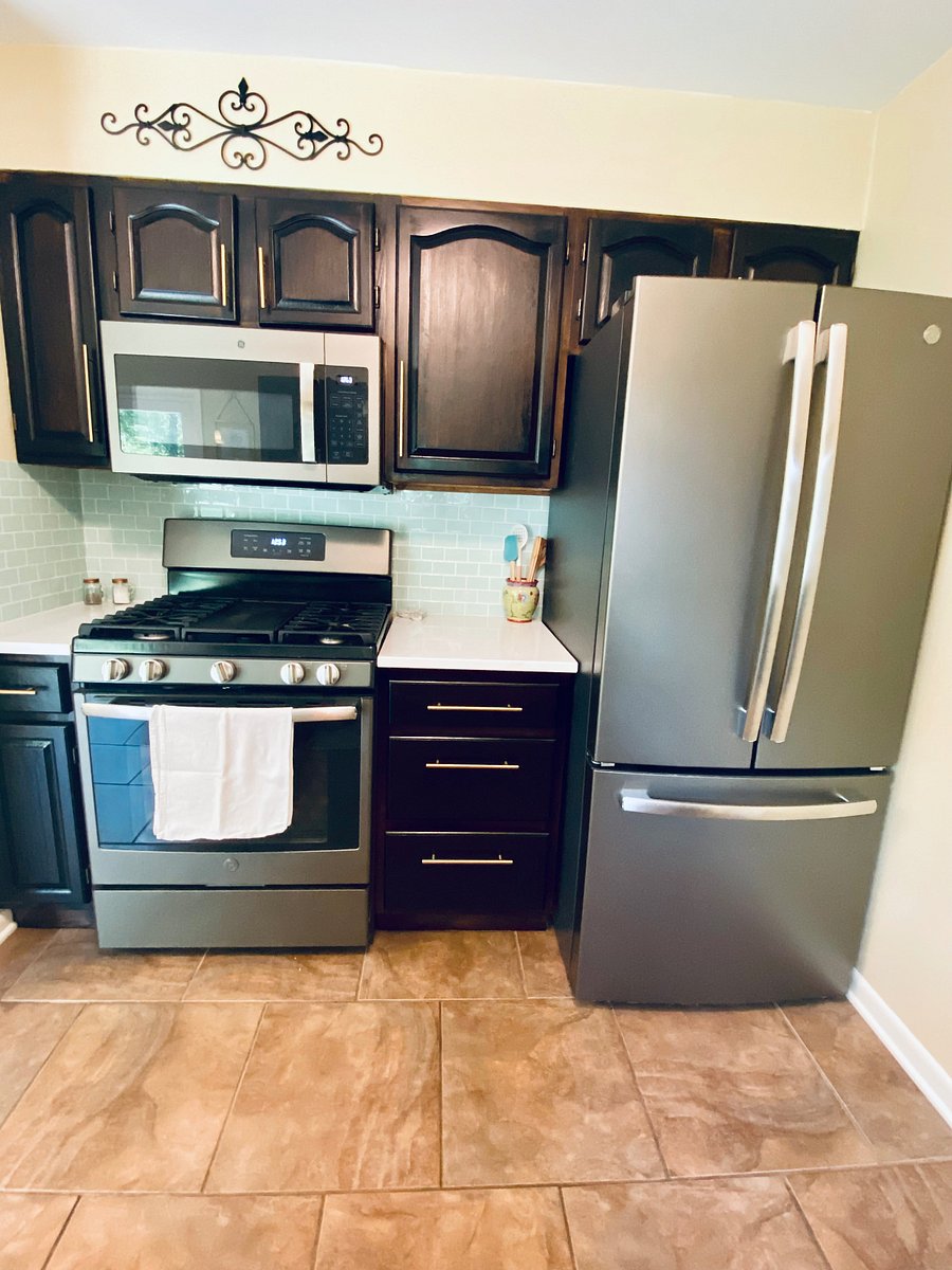 Features a full-size gas range, stainless steel appliances, and large fridge.