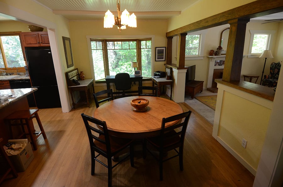 Dining room open to kitchen, desk and printer, etc. in bay window.