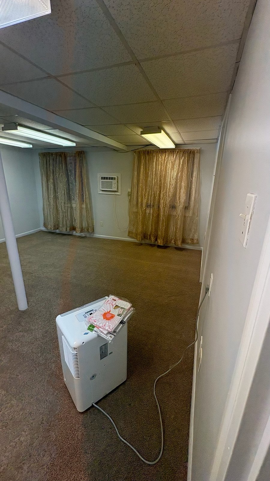 bedroom with have brand new furniture queen bed and two end tables and dresser with air conditioner in wall . i supply a dehumidefier