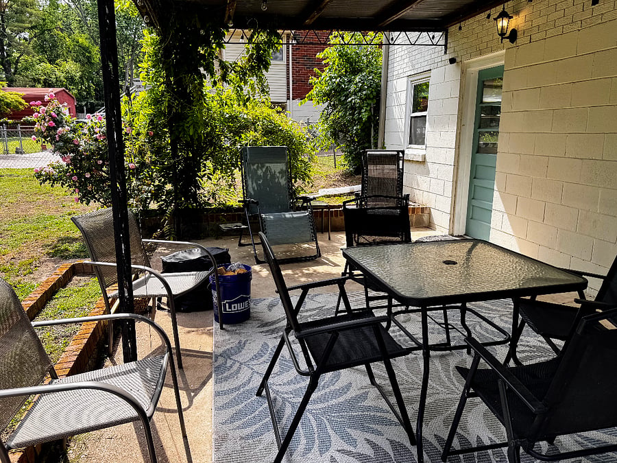Enjoy the shared covered patio with rose bushes.