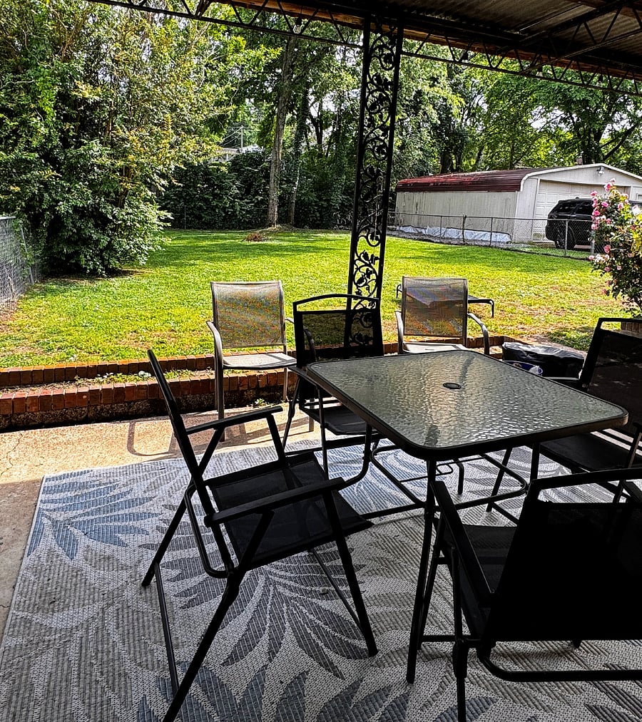 A fenced in yard where you can enjoy your morning coffee.