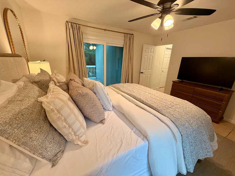 Master bedroom features black out curtains and white noise machine with a Smart TV