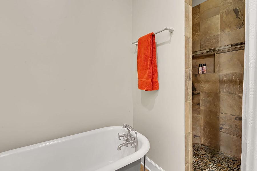 Double shower heads (each with their own temp control), new tiling and stonework, in-wall storage shelf for shampoo etc., and a corner seat (just barely peeking out in this photo!).