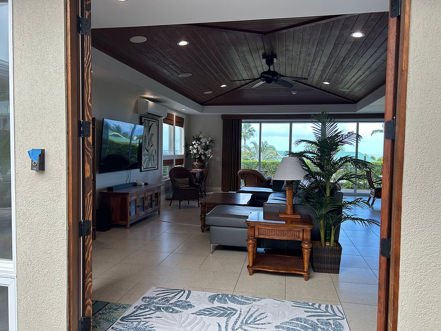 Welcome to your home away from home.  Hawaiiana style greets you in this open concept great room. Comfortable seating for eight.  Six panel sliding doors and screens open to bring the tropical breezes inside; it also is equipped with a mini split ac unit
