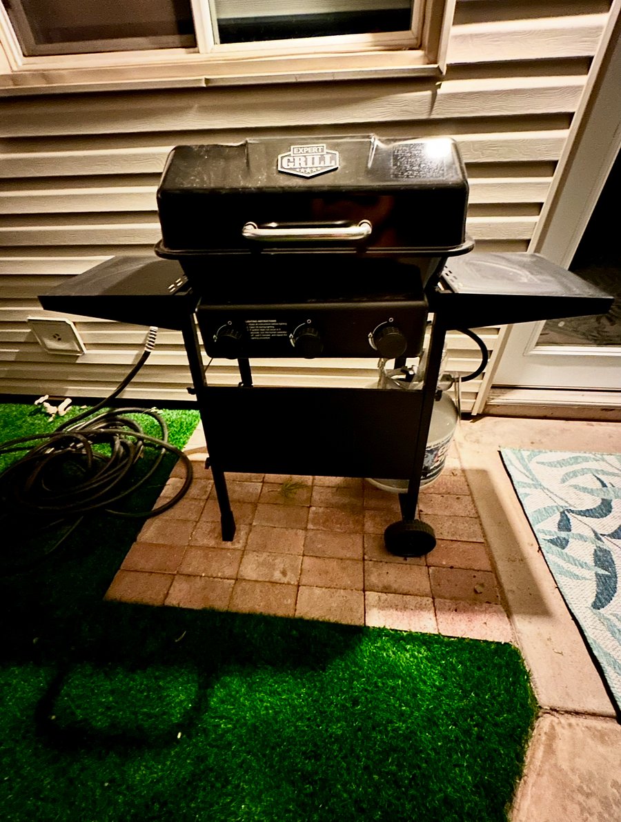 Propane BBQ under covered furnished patio.