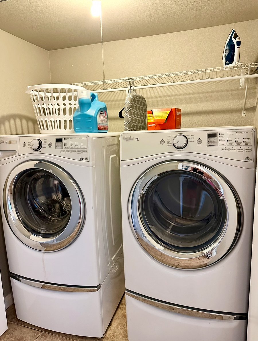 Full-size washer & dryer in an enclosed closet downstairs.
