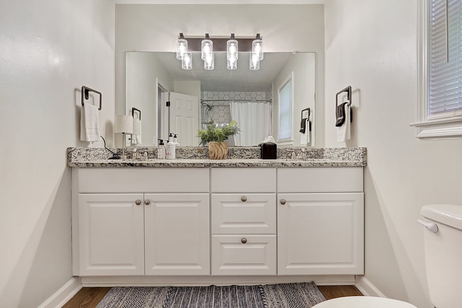 Full Bathroom with dual sinks and ample cabinet space