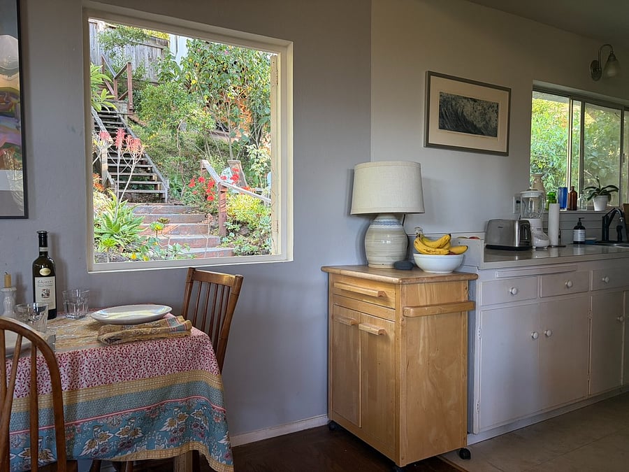 Kitchen and dining table face the front garden with stairs to the street