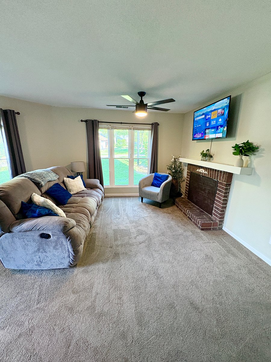 Living room with Roku smart TV and reclining couch (2 seats recline and middle has cup holders that fold down)