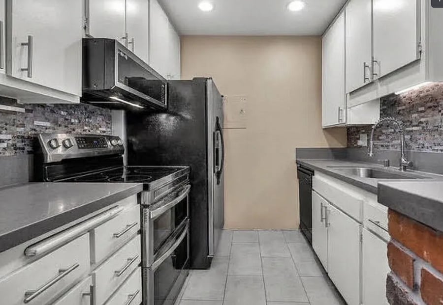 Kitchen with smart appliances, pots/pans, and dishes