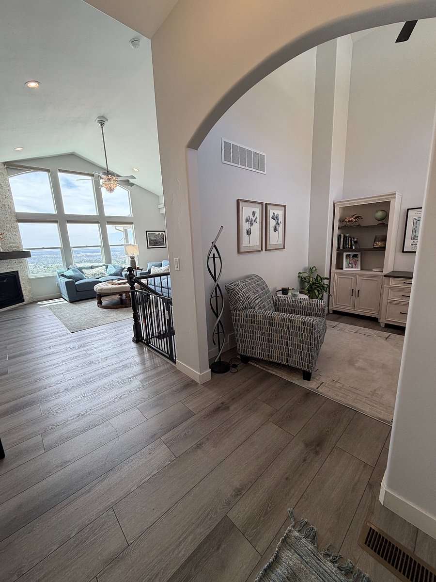 A striking entry showcasing the home's open-concept design and expansive wall of windows.