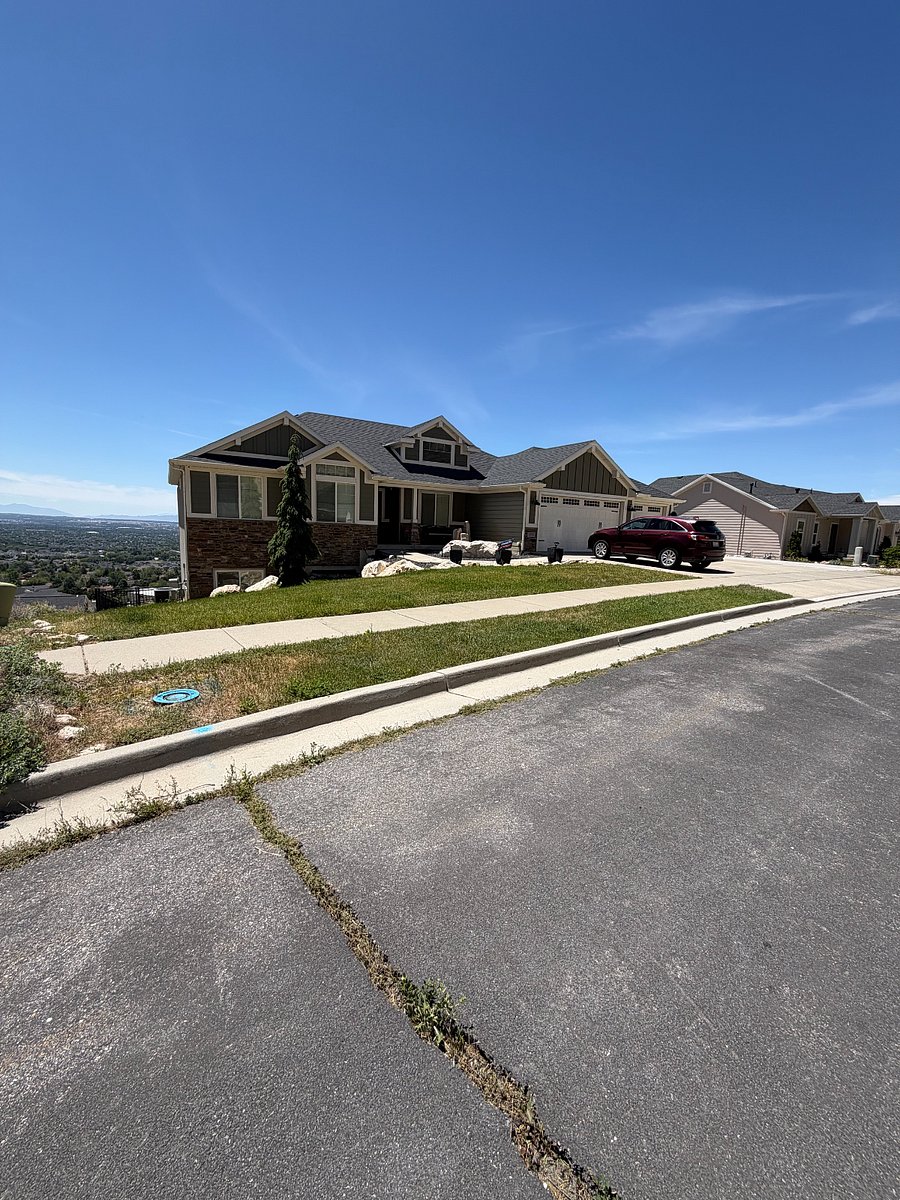 Well-maintained home with both garage and ample driveway parking in a quiet hillside neighborhood.