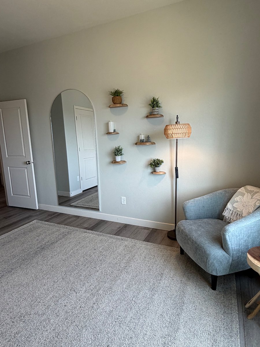 Thoughtfully designed wellness space with curated dcor, full-length mirror, and meditation-inspired touches.