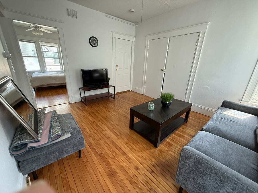 Living room with beautiful hardwood floors. Mirror to be hung after holiday