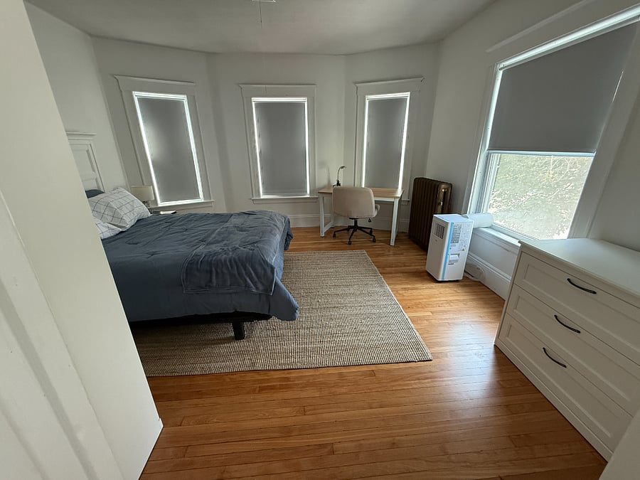 Bright bedroom with room darkening shades. Queen bed, desk, dresser  and a wonderful wardrobe closet. Portable AC unit for cool summer days.