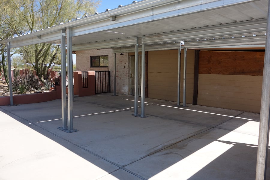 In addition to front circular driveway there are 2 covered carports in back of house with access to back yard.