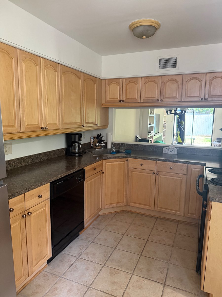 Kitchen with pass-through view into dining and living areas.