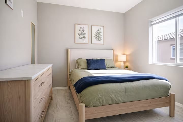 Enjoy a restful night's sleep in this inviting bedroom, offering comfortable accommodations and convenient built-in storage for longer stays.
