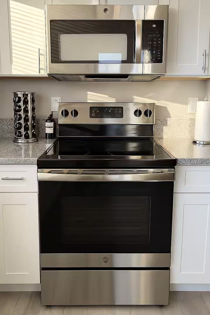 Fully equipped kitchen featuring stainless steel appliances, ample counter space, and everything you need to cook and feel at home. Pots are located in lower cabinets.