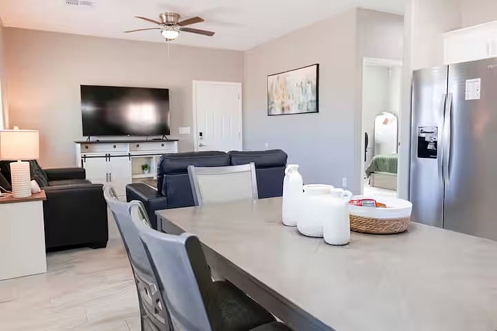 Open-concept dining and living space with a large table perfect for meals, work, or gathering together after a long day.