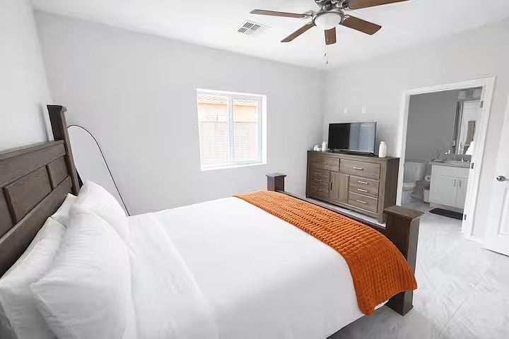 Peaceful Master bedroom with a comfortable bed and soft linens designed for a restful nights sleep.