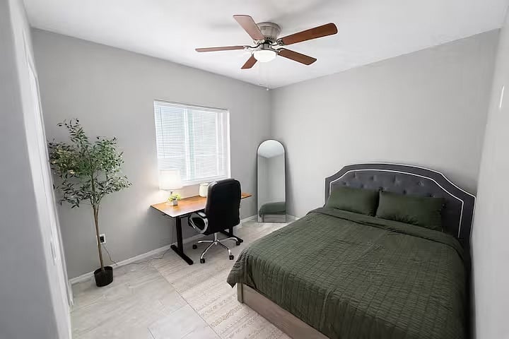 Comfortable bedroom with a cozy bed, dedicated workspace with desk and chair, and an additional pop-up bed available in closet for extra guests. Perfect for remote work, families, or small groups.