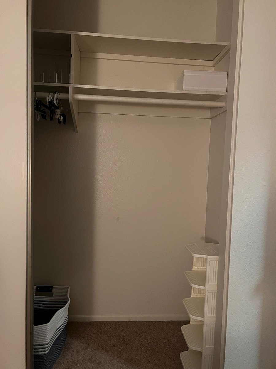 View from window angled towards closet (shoe rack, laundry basket, shelving)