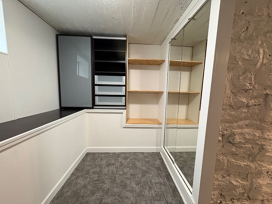 Walk-in closet with dresser and shelves