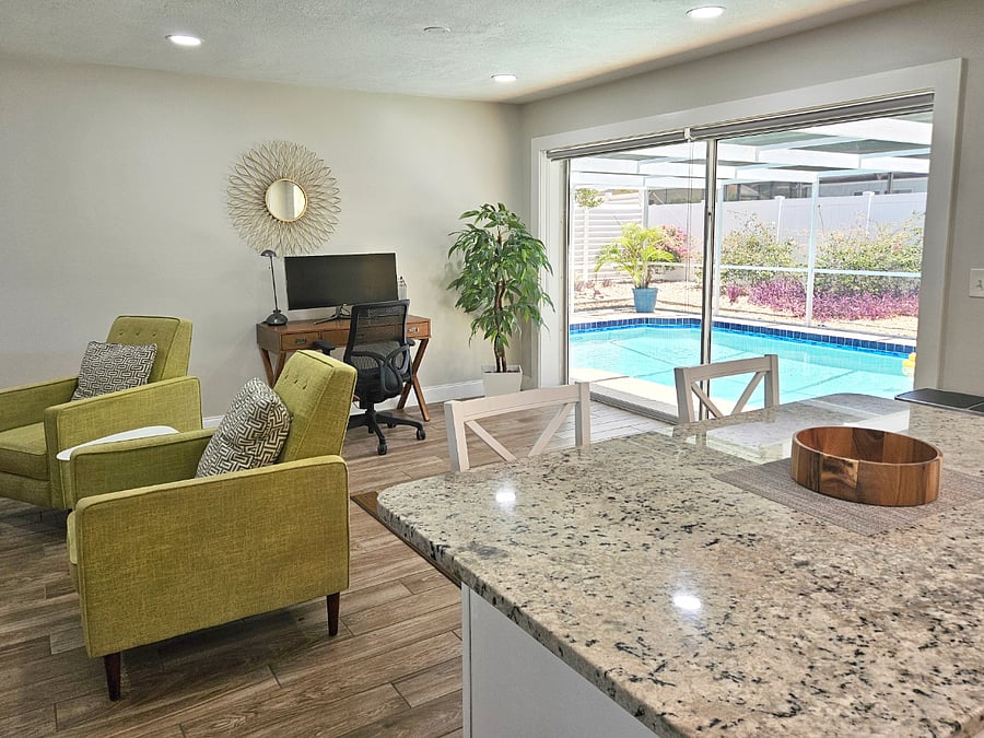 Kitchen looks out to the pool and patio.