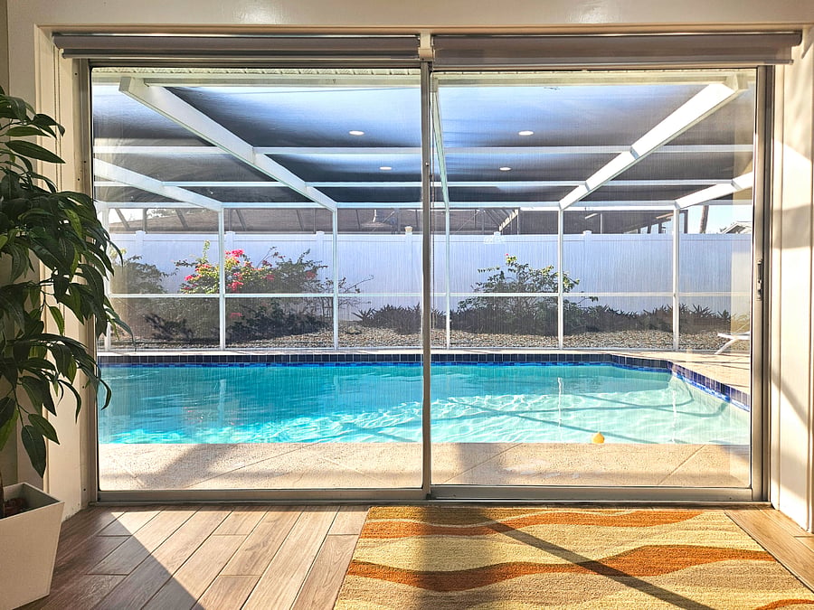 Large Glass Sliders lead out to the screened patio and pool.