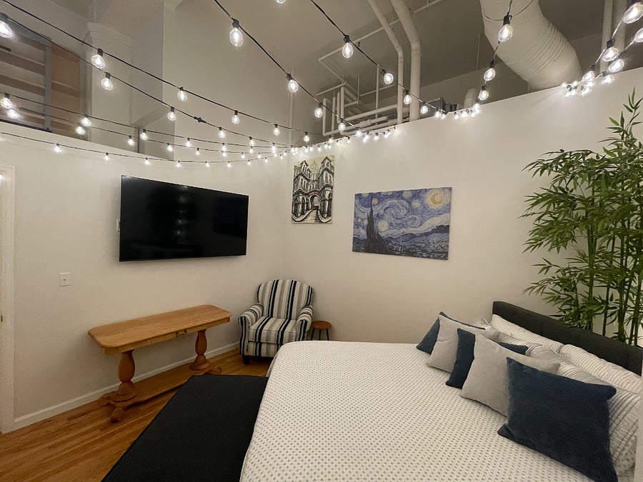 Master bedroom featuring a mounted 65" Samsung Smart TV