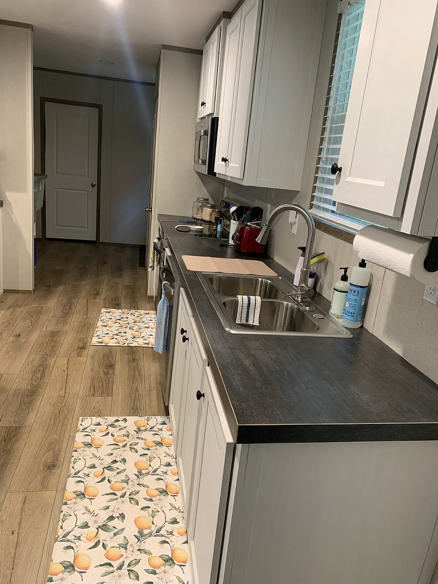 Double stainless steel kitchen sink with dishwasher.