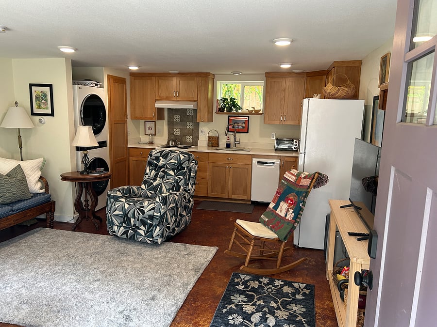 The front door opens into a large living room and kitchen area. The fully-equipped kitchen also includes a refrigerator, stove/oven, dishwasher, toaster oven and microwave.