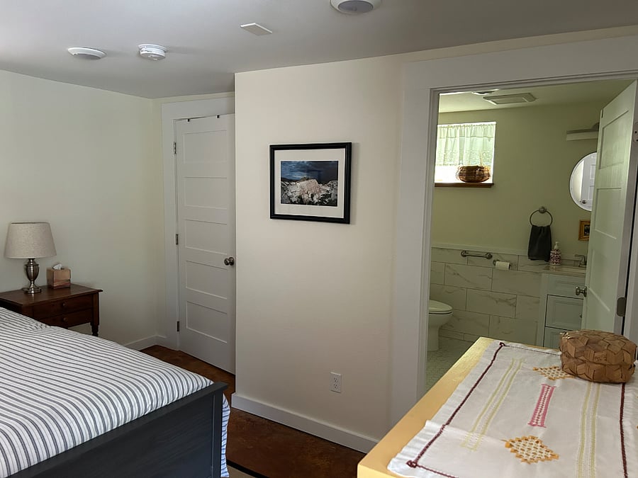 The bathroom is located off the bedroom.