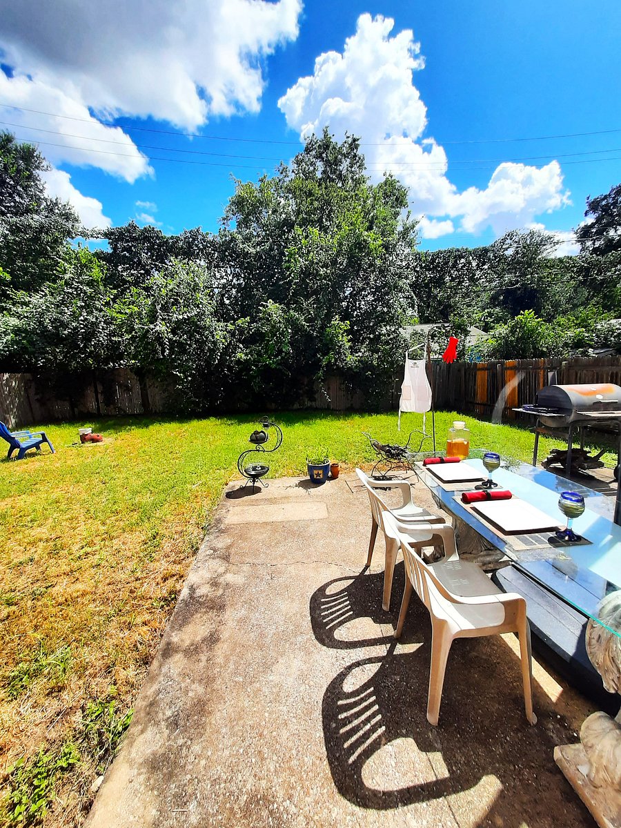 Large backyard glass table with chairs barbecue