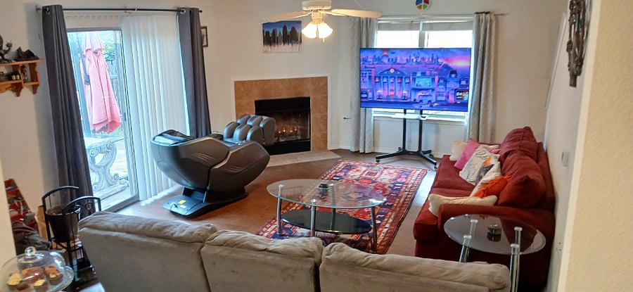 Living room w/ Comfier Massage Chair, big screen tv, & reclining couches