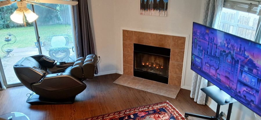 Living room w/ Comfier Massage Chair 360, big screen tv, & reclining couches Wood burning fireplace