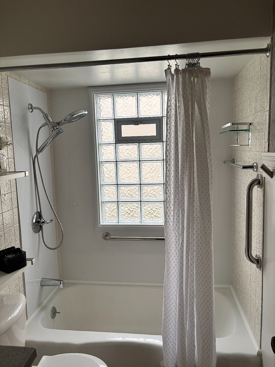 Main floor bathroom. Bathtub, vanity, two shelves over the toilet. Hair dryer, fan and heater.