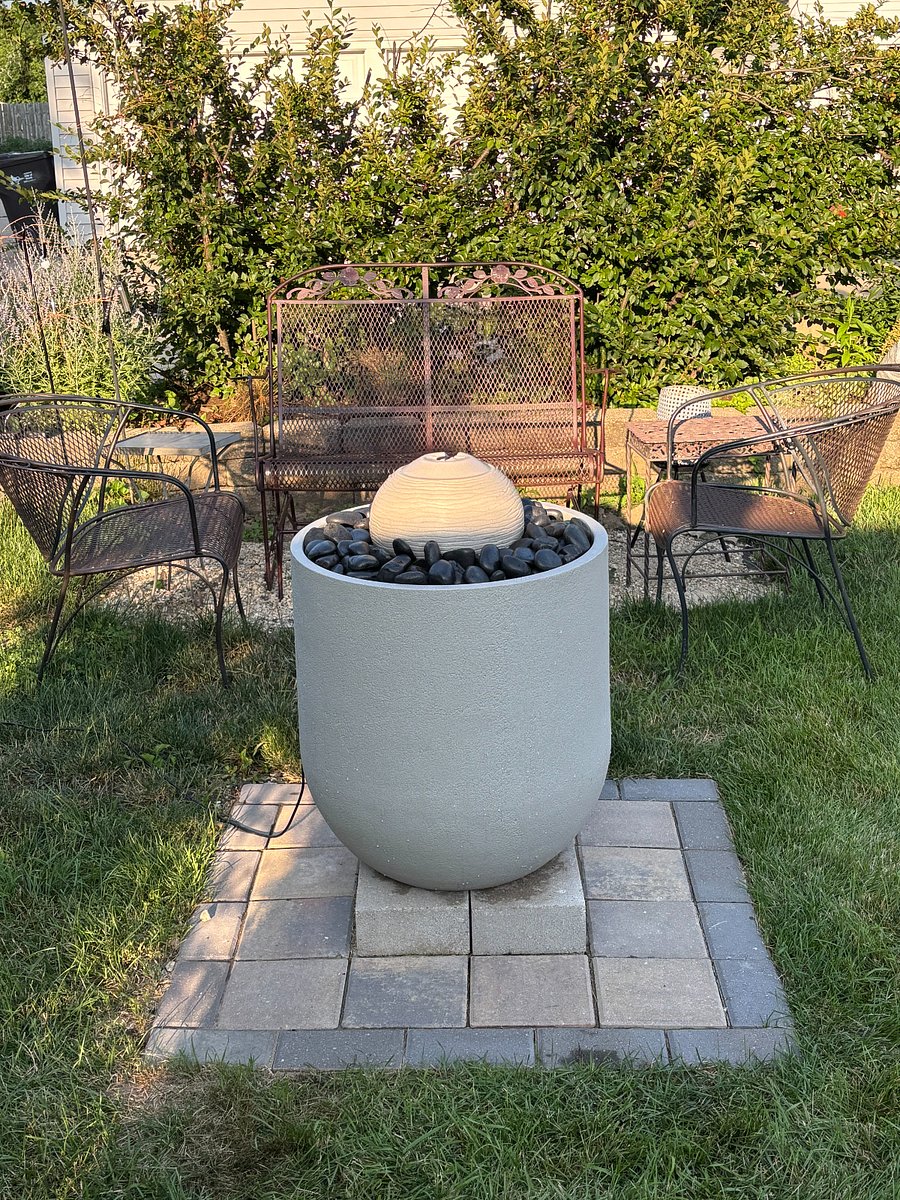 Relaxing sitting area with a solar fountain in summer and a lighted feature in winter.