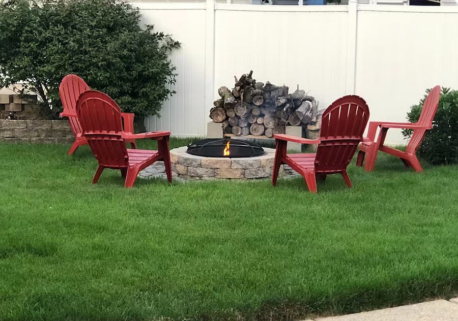 Fire pit area with Adirondack chairs.