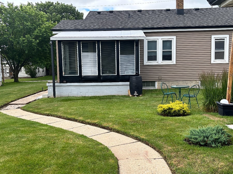During the summer, the property requires ongoing maintenance, including lawn mowing and bush trimming.